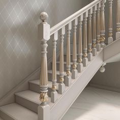 a white staircase with gold and silver decorations on the balconies, next to a wallpapered wall