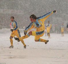 the soccer players are playing in the snow