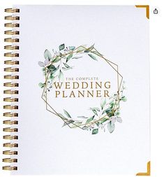 a wedding planner with greenery on the front and back cover is shown in white