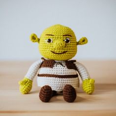 a small crocheted toy sitting on top of a wooden table