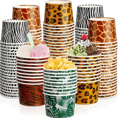 many cups with different designs on them and one has an ice cream sundae in the middle