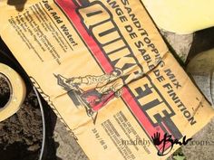 a yellow bag sitting on top of a pile of dirt