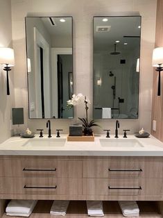 a large bathroom with two sinks and mirrors