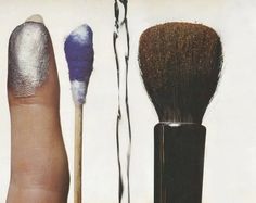 a hand holding a brush next to two other brushes