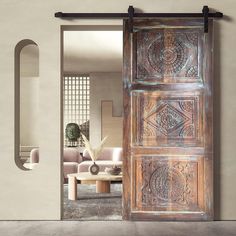 an open wooden door in front of a living room