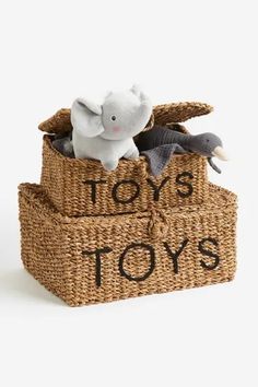 a toy elephant sitting in a basket with toys on it that says toys, toys