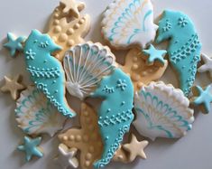 decorated cookies are arranged in the shape of seahorses