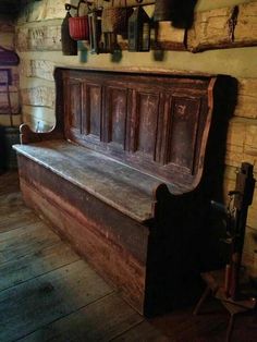 an old wooden bench sitting in the corner of a room