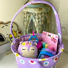 a purple basket filled with toys on top of a table