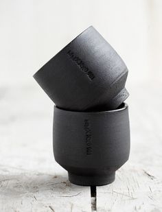 two black cups sitting on top of each other