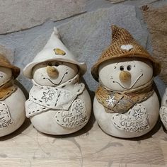 four ceramic snowmen with hats and scarves