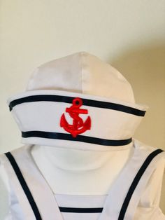 White cotton sailor style hat with stiff turned up brim. I have made this hat in white and trimmed it with navy and red but it could be made in any colour upon request.  Please measure your child's head to ensure you buy the correct size.  I sell matching outfits for boys and girls. I have posted the links to these outfits below: https://www.etsy.com/uk/listing/1396483714/sailor-style-cotton-romper-white-and?click_key=2d01704e16ba0e0c2ff6cb8daf1db28196ba6018%3A1396483714&click_sum=4ef894a8&ref=shop_home_active_6&sts=1 https://www.etsy.com/uk/listing/1061637011/sailor-dress-in-white-with-navy-blue-and?click_key=37f284b234e73eca7ad1df78d19b34acfea0e81a%3A1061637011&click_sum=32b635c7&ref=shop_home_active_12&crt=1&sts=1 How To Make A Sailor Hat, Adjustable Sailor Cap, Red Sailors Hat, Baby Sailor Outfit, Toddler Sailor Dress, Sailor Baby, Navy Ribbon, Sailor Hat, Sailor Fashion