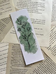 a bookmark that has been placed on top of some old books with writing paper around it