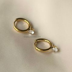 Savor the timeless elegance and brilliance of our Round Brilliant Moissanite Earrings. Round cut diamond earrings, hanging stud, yellow gold earrings, luxury earrings, bridal earring, anniversary gift, women's jewelry, handmade earrings, minimalist earrings, diamond gold earring, hanging diamond stud.    ❖ 𝐃𝐞𝐬𝐜𝐫𝐢𝐩𝐭𝐢𝐨𝐧 𝐎𝐟 𝐃𝐢𝐚𝐦𝐨𝐧𝐝 ❖ ✥ Moissanite details ➜ Center Diamond cut : Round ➜ Center Diamond weight : 0.40 CT ( Approx ) ➜ Center Diamond Measurement: 3.50 mm ➜ Stone Color: Luxury Round Cut Huggie Earrings For Gift, Luxury Timeless White Gold Huggie Earrings, Elegant Gold Diamond Earrings With Brilliant Cut, Elegant Formal Huggie Earrings With Single Diamond, Classic Gold Huggie Diamond Earrings, Classic Gold Diamond Drop Earrings, Luxury Gold Diamond Earrings For Anniversary, Classic Gold Huggie Earrings With Brilliant Cut, Timeless Gold Huggie Earrings With Brilliant Cut