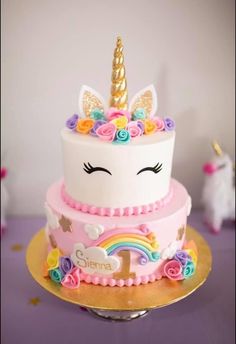 a cake with a unicorn face on top of it