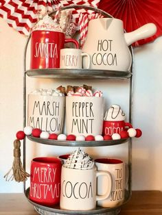 three tiered tray with coffee mugs and candy canes on the bottom shelf