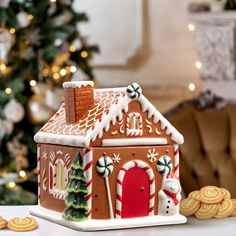 a gingerbread house and cookies on a table