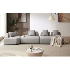 a living room filled with furniture next to a white rug and wooden wall mounted lamp