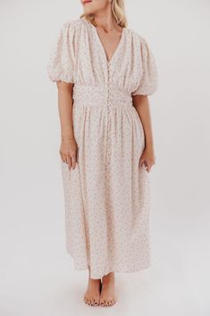 This beautiful dress is an elegant nod to simpler times; from its modest neckline, to its puffed sleeves and cinched waist, the Billie Maxi Dress is equal parts charming and feminine. It's a gorgeous choice for everyday wear, or style it with pumps for church or a baby shower! FIT: Runs true to size. MATERIAL: 100% Cotton GARMENT DETAILS: Ditsy print maxi dress, with a modest V-neckline and ballooned short sleeves. Features a cinched waist with pleats, a full skirt, and a pleated back panel. SIZE GUIDE: S (2-4) / M (6-8) / L (10-12) / XL (12-14) / 1XL (14-16) / 2XL (18-20) / 3XL (22-24) MODEL DETAILS: Mackenzie - Size S Heather - Size S Molly - Size XL Our Brunette Misses Model Our Blonde Misses Model Our Blonde Curve Model Bust 34" 34" 37" Waist 27.5" 27.5" 32" Hips 40.5" 37.5" 47" Height Modest Neckline, Simpler Times, Curve Model, Pleated Maxi Dress, Pleated Maxi, Puffed Sleeves, Cinched Waist, Full Skirt, Printed Maxi Dress