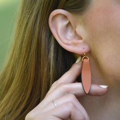 Our Brown Fold Over Leather Earrings earrings offer up modern style that's simple and eye catching. Each pair comes with 2 rubber earring backs (be sure to wear these with your earrings!) Leather is folded over a gold-fill finding, creating a petal shape.  This listing is for brown leather, this style is also available in black leather.Finishes + Details: Earrings are made from authentic leather. All findings are gold-fill.Dimensions: Earrings hang approximately 2-inches down.Country of Origin:E Adjustable Drop Earrings For Everyday Use, Elegant Everyday Nickel-free Earrings, Elegant Nickel-free Earrings For Everyday Use, Nickel-free Drop Earrings For Everyday, Dangle Earrings For Everyday Use, Everyday Dangle Earrings, Leather Accessories Diy, Handmade Leather Jewelry, Diy Leather Earrings