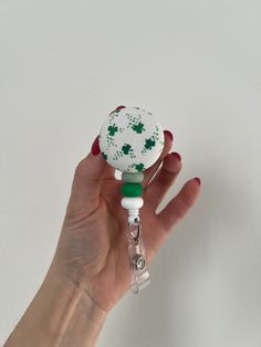 "St Patty badge reel with silicone beads  Required to wear your badge to work? This retractable badge reel would be a unique way to personalize your work attire! Students, teacher, nurses, dentists and all others!  Velcro placed on back to be interchangeable but if you want permanent just let me know!  Just message me if you want a custom request, I look forward to hearing from you! Alligator clip or belt clip options 🌟Retracts 34\"  🌟3/4 diameter velcro button  🌟Silicone beads 🌟interchangeable button topper" Adjustable White Badge Holder For Hobby, Handmade Adjustable White Badge Reel, Nurse Badge Reel, Button Badge, Nurse Badge, Retractable Badge Reel, Belt Clip, Silicone Beads, Badge Holders Lanyard