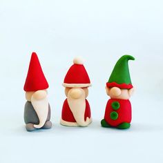 three gnome figurines sitting next to each other