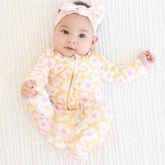 This extra cozy footie featuring charming pink and yellow flowers will have every parent falling even deeper in love with their little girl! The full-length zipper makes it easy to dress your baby quickly, while also ensuring that the footie stays securely in place. Adorable ruffles on the bottom brings the cutest twist to this cheerful outfit. Made from high-quality bamboo viscose, this footie is soft and gentle on your baby's delicate skin and will keep your little one comfy all day long! One- Fitted Footie For Loungewear Spring, Spring Loungewear Footie, Spring Loungewear Fitted Footie, Cute Yellow Onesie For Loungewear, Yellow Onesie For Spring, Playful Yellow Onesie For Loungewear, Pink Onesie For Bedtime In Spring, Cute Spring Onesie For Bedtime, Spring Long Sleeve Footie For Bedtime