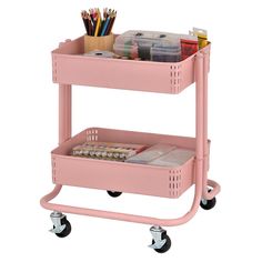 a pink rolling cart with two trays on it and some pens, pencils, and other office supplies