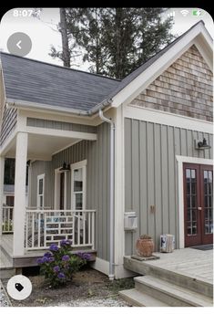 a small house with steps leading up to the front door