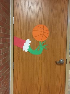 a door decorated with a basketball and pom poms