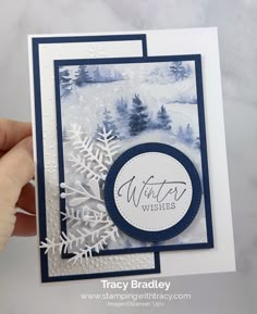 a hand holding up a card with snowflakes on it and the words winter wishes