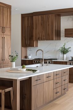 a kitchen with wooden cabinets and white marble counter tops, along with an island in the middle