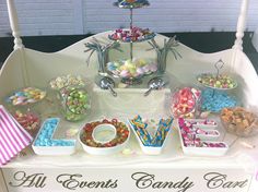 a candy bar with all sorts of candies and sweets on the table for guests to eat