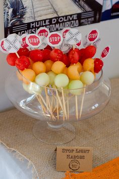 a bunch of lollipops sitting on top of a glass bowl filled with candy