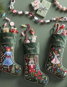 three christmas stockings hanging on the wall next to other items and decorations, including candy canes