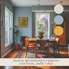 a dining room with blue walls and wooden floors