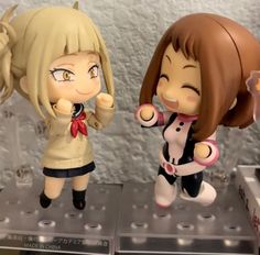 two anime figurines on display in a store