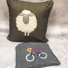 two pillows, one with a sheep on it and the other with beaded buttons