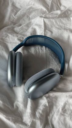 a pair of headphones laying on top of a white sheet