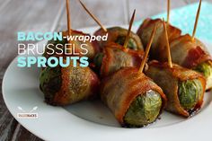 bacon wrapped brussel sprouts on a white plate with the words bacon wrapped brussel sprouts