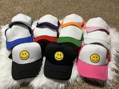 Multiple colors available. The latest trend! Trendy White Winter Baseball Cap, Casual Smiley Face Snapback Baseball Cap, Trendy Trucker Hat With Curved Brim, Trendy White Baseball Cap, Trendy Winter Snapback Hat For Streetwear, Trendy Winter Snapback Hat, Trendy Winter Trucker Hat, Trendy Smiley Face Baseball Cap With Curved Brim, Casual Smiley Face Snapback Hat