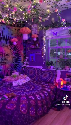 a bedroom decorated in purple and pink with lights strung from the ceiling, bedding, and decorations