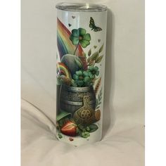 a stainless steel tumbler with shamrocks and fruit on it