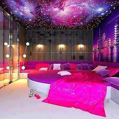 this is a bedroom decorated in pink and purple colors with stars on the ceiling above it