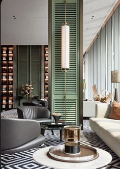 a living room filled with lots of furniture next to a tall green wall covered in wooden slats