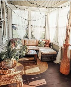 a sun room with wicker furniture and plants