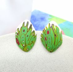 "* These one of a kind  abstract green studs are very lightweight and comfortable to wear.  * The nickel free steel closure is securely fixed in the base of the earrings, that makes it durable. ➣ SIZE: Lenght:   3,5 cm (1.38') Width:   2,5 cm (0.98') Weight of each earring: 4 g  PLEASE check the size carefully. The earrings may appear larger on the photos. ➣ORDER & DELIVERY: Earrings are ready to ship. They're packed in a cute small box and an envelope/cardboard to arrive safely. ➣GIFT WRAPPING: Is your purchase a gift? I'll wrap your gift nicely, add a handwritten tag/card with your text (optional). Just select a \"Gift wrapping\" during the checkout. ➣MATERIAL: Polymer clay, Hypoallergenic nickel free steel. ➣CARE RECOMMENDATIONS: Polymer clay is a long-lasting material. To enjoy your je Whimsical Green Hand Painted Earrings, Hand Painted Green Earrings In Polymer Clay, Green Hand-painted Polymer Clay Earrings, Green Hand Painted Polymer Clay Earrings, Hand Painted Green Polymer Clay Earrings, Green Hand Painted Artistic Earrings, Unique Green Polymer Clay Earrings, Green Hand-painted Polymer Clay Jewelry, Green Hand Painted Polymer Clay Jewelry