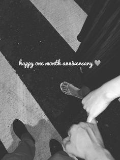 two people standing next to each other on a cross walk with the words happy one month anniversary