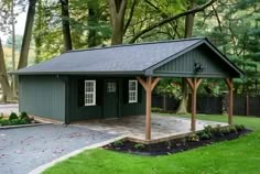 a small green shed sitting in the middle of a yard