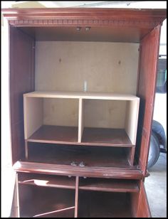 an empty wooden cabinet with shelves and drawers